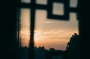 How to reset your life when everything feels too much. Image shows the sunrise and sky through a window