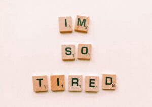 Why you still feel overwhelmed even when you’re trying your best. Image shows letter tiles reading ‘I’m so tired’ 