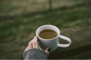 The Science Behind Morning Sunlight and Why It Changes Your Mood. Image shows a hot drink outdoors