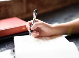 Different types of journaling. Image shows a hand writing in a journal