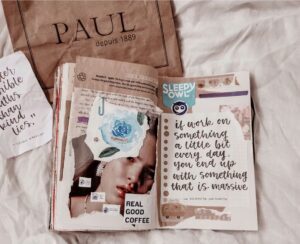 Journal styles. Image shows a closeup of collage in a notebook on a bed