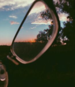 Journaling for clarity. Image shows an in focus countryside view through a pair of spectacles
