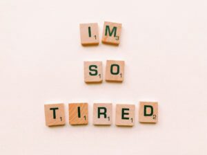 Image shows letter tiles spelling ‘I am so tired’