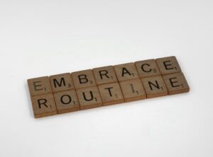 Image shows letter tiles spelling ‘embrace routine’ 