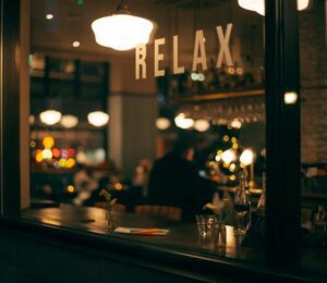 Image shows a mirror with lighting, and a decal that reads ‘relax’