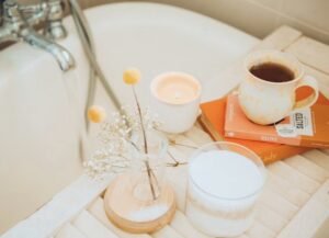 Sunday evening reset routine - image shows a bubble bath with a bath tray holding a candle, a book, some flowers and a hot drink